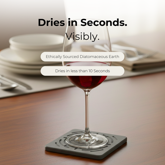 Wine glass on a coaster with text about quick drying properties Close-up of a stone coaster instantly absorbing condensation from a cold glass.