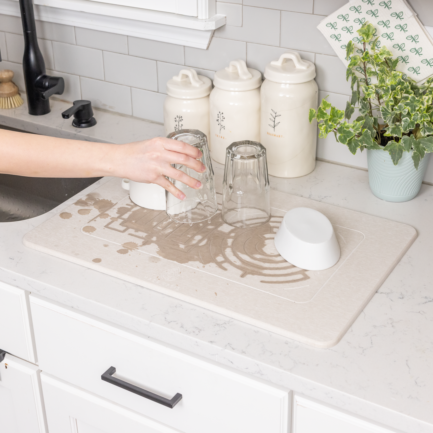 A clutter-free dish drying solution using a flat stone mat.